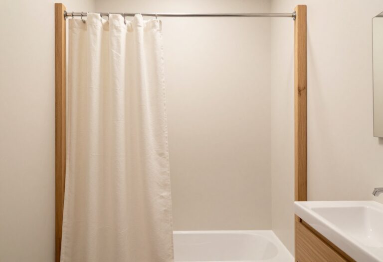 Elegant bathroom with a warm neutral fabric shower curtain and wooden accents