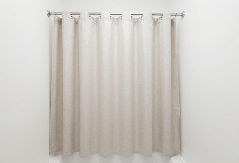 A small bathroom with a double shower curtain arrangement, showing an outer fabric curtain and inner liner for enhanced privacy and style in home decor.