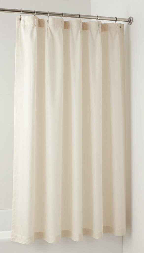 A curved shower curtain rod with a single fabric curtain in a neutral color, enhancing bathroom style and openness without plastic liner.
