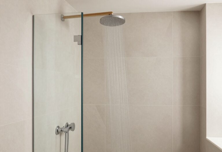 Modern master bathroom shower with geometric tiles, frameless glass, and wood accents, creating a luxurious and serene space.