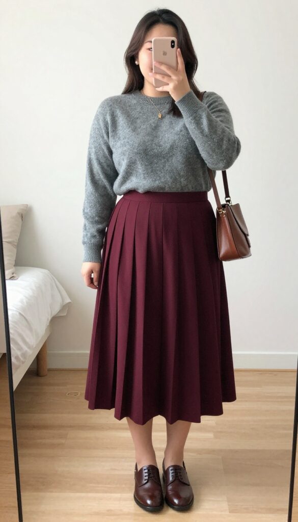 Burgundy pleated skirt with gray cashmere crewneck and oxfords