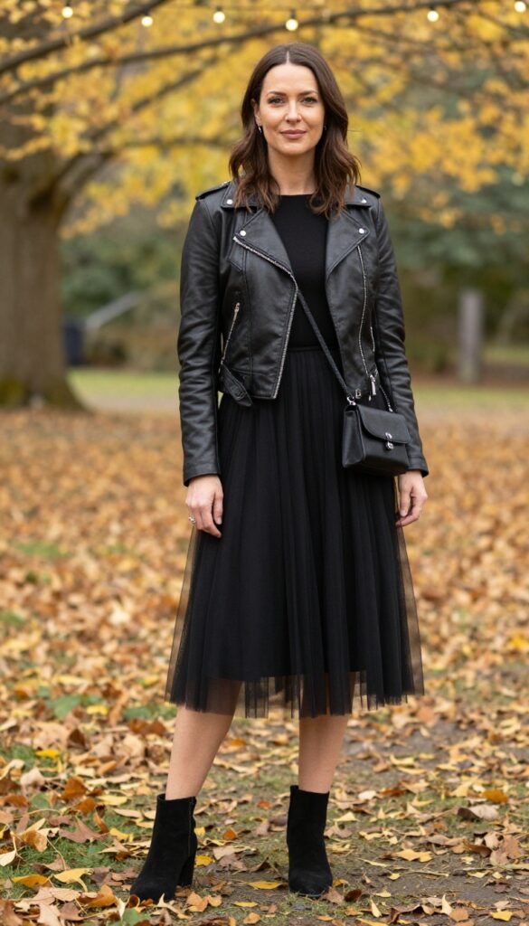 Woman in black tulle dress and leather jacket at outdoor fall wedding