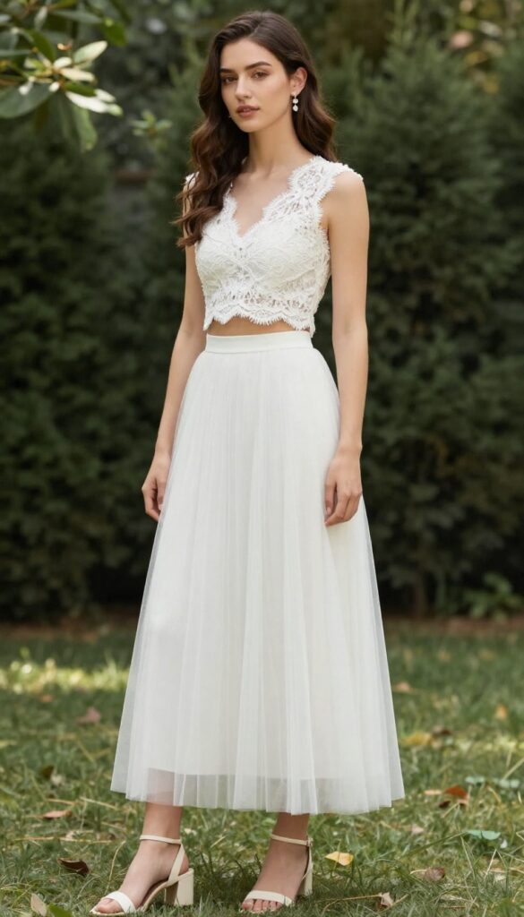 Woman in white lace crop top and high-waist tulle skirt in sunlit garden
