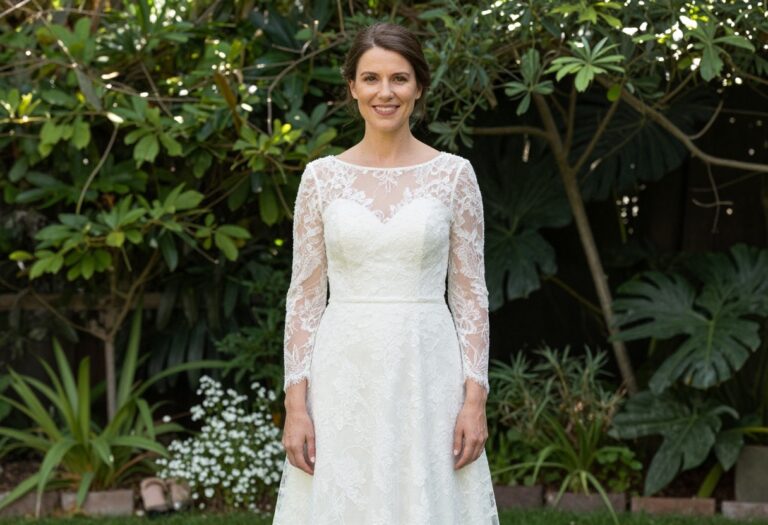 Woman in lace sleeve wedding dress standing in garden