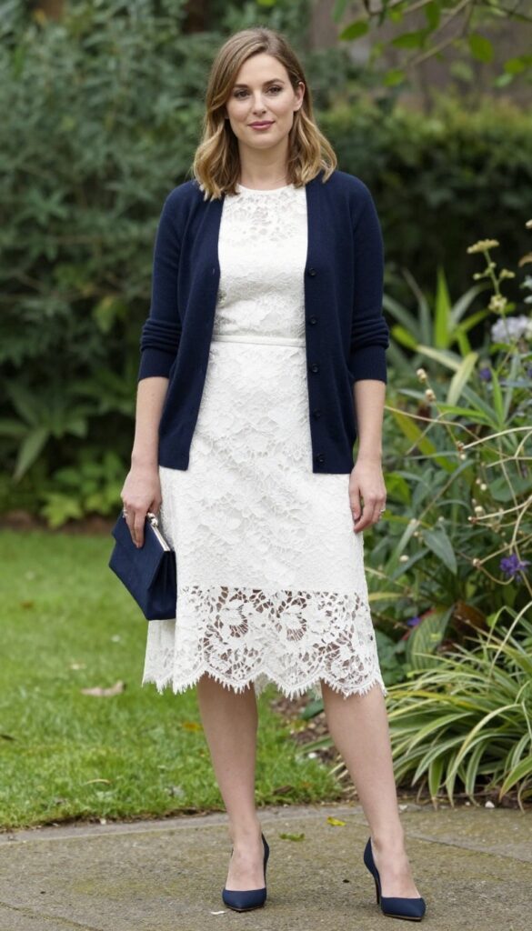 White lace dress with navy cardigan and heels for wedding guest outfit