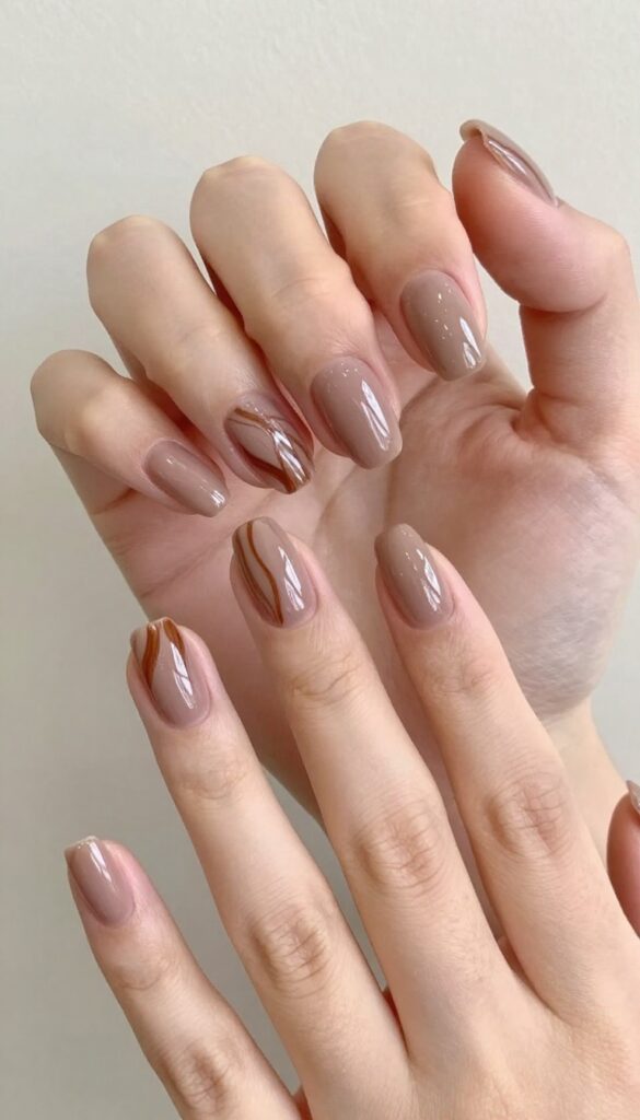 Mocha swirl dip powder nails with glossy finish and medium almond shape
