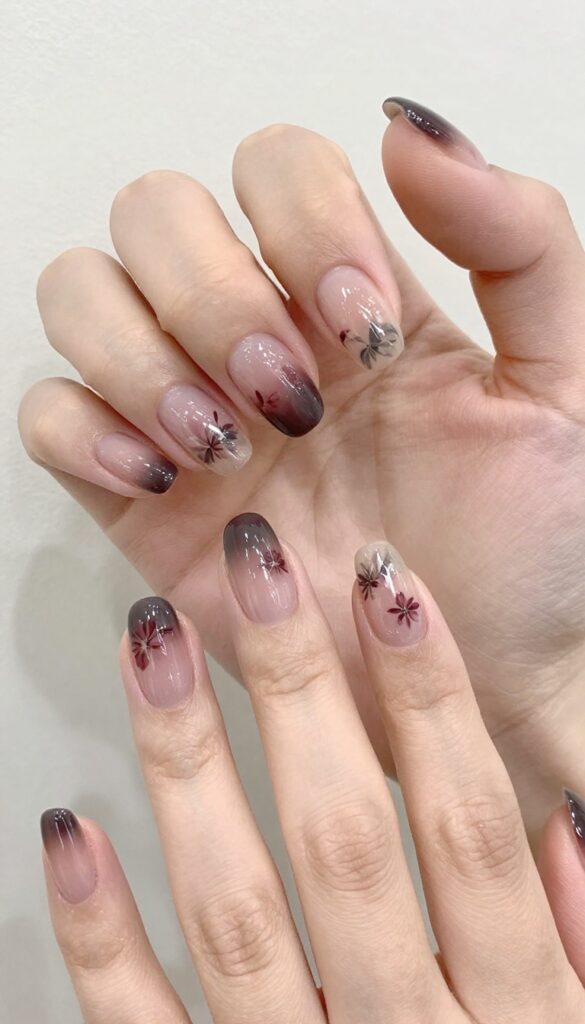 Midnight petal nails with dark glossy base and floral decals
