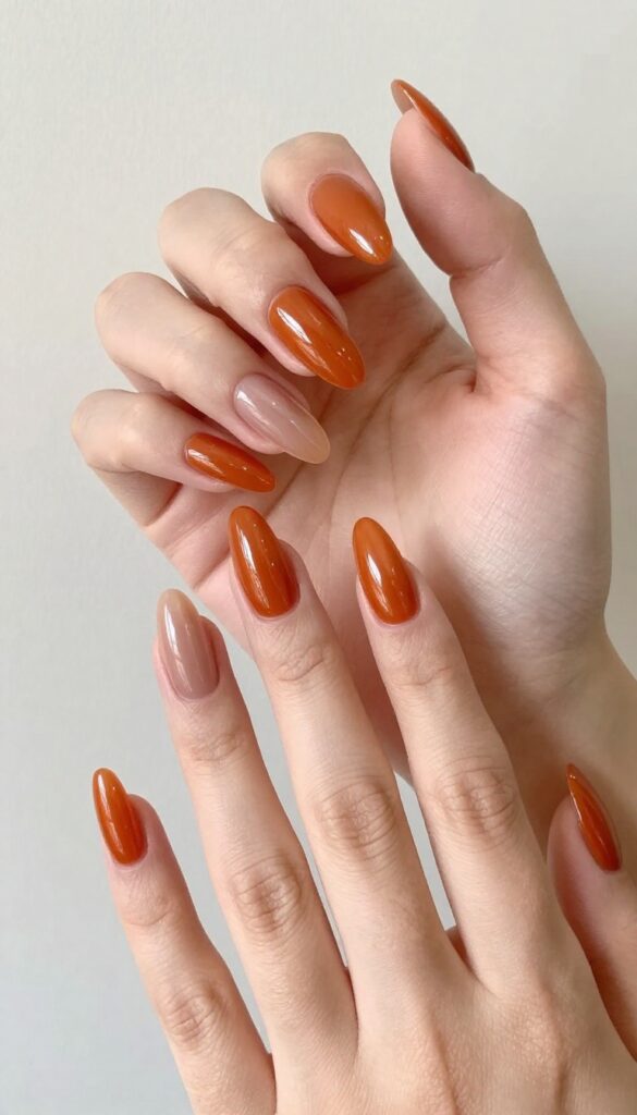 Glazed ginger orange stiletto nails with high-gloss finish