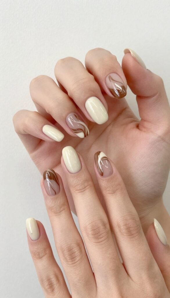 Mocha swirl nails with glossy finish on rounded almond shape
