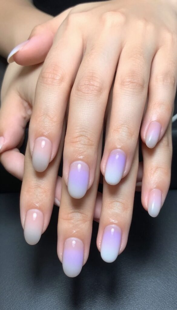 Ghostly ombré fade nails with sheer nude base and pale lavender tips, matte finish