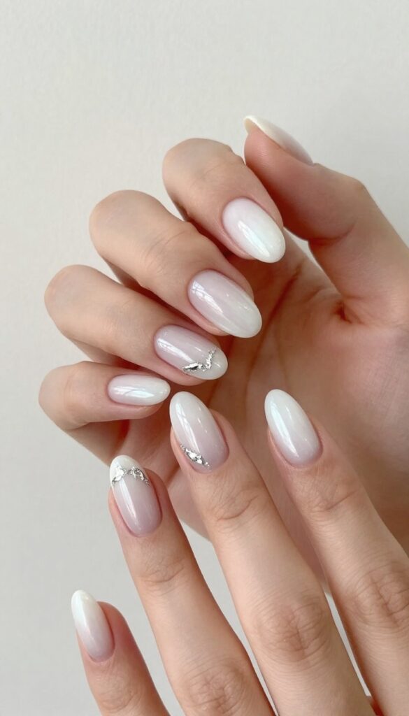 Pearlescent white stiletto nails with silver foil accents