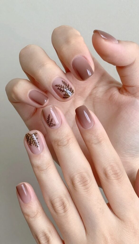 Sheer mocha nails with pressed fern fronds near cuticles, matte finish