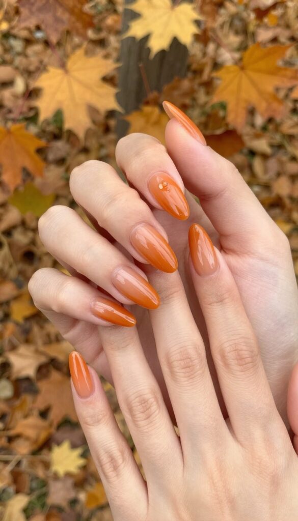 Glazed ginger orange stiletto nails with glossy finish