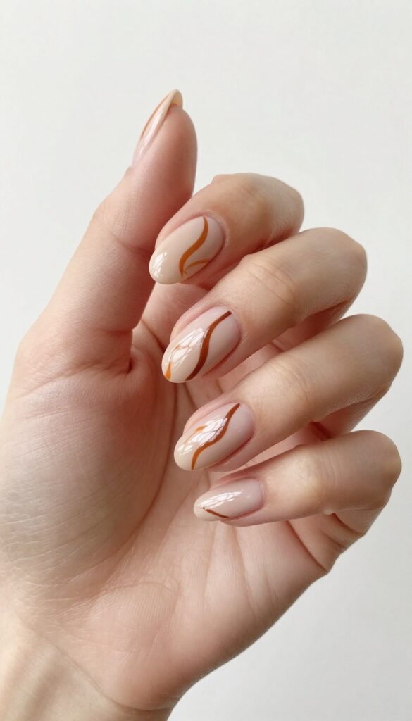 Burnt orange swirls on nude almond acrylic nails