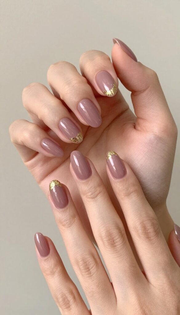 Pearlescent mauve nails with gold foil accents, almond shape, glossy finish