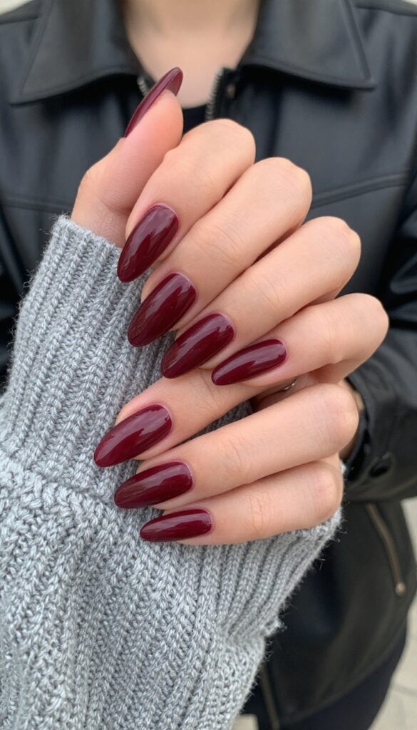 Classic wine-dipped almond nails with glossy burgundy polish