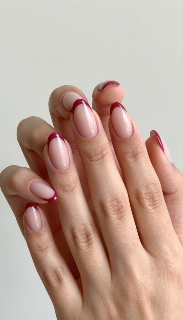 Cranberry French tips with a twist on almond-shaped nails