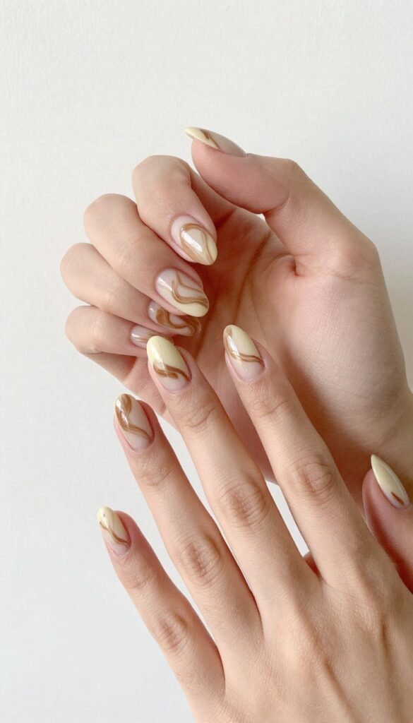 Mocha swirl gel nails with creamy brown base and espresso marble pattern on almond-shaped nails