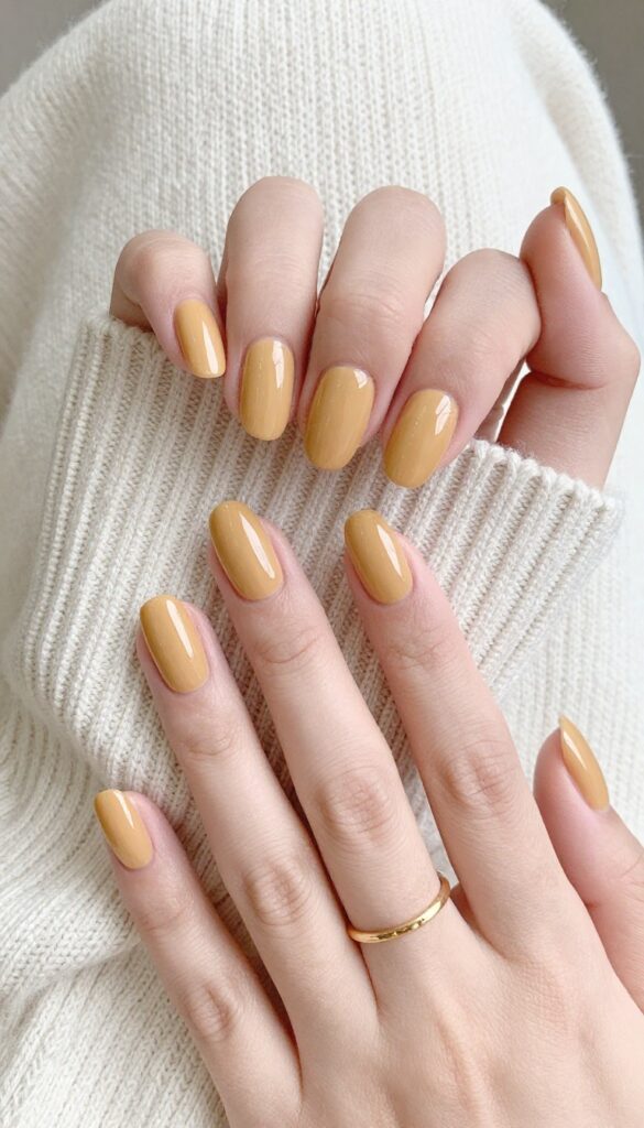 Glazed pumpkin spice nails with glossy finish on almond-shaped nails