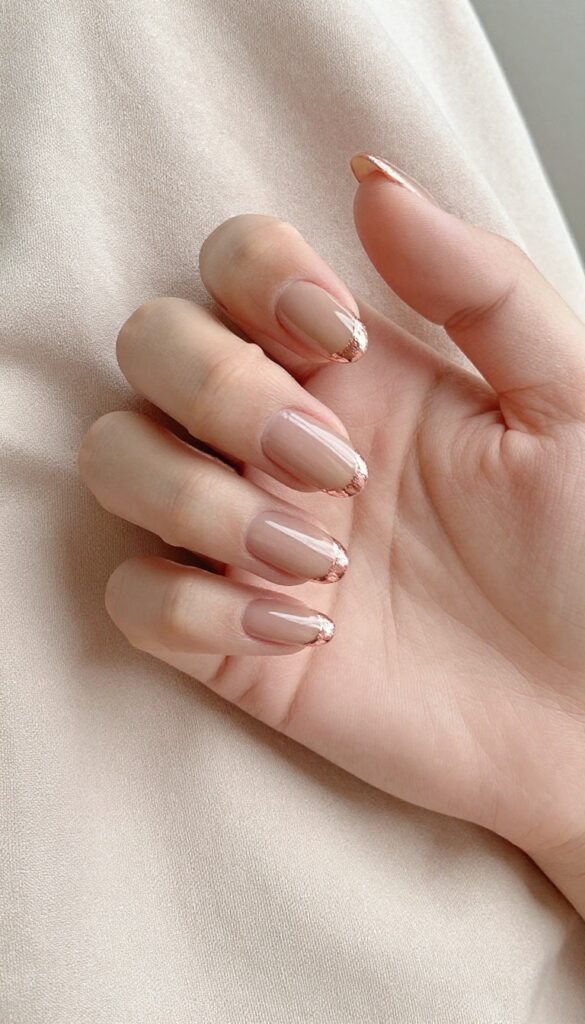 Rose gold foil tips on almond-shaped nails with sheer nude base