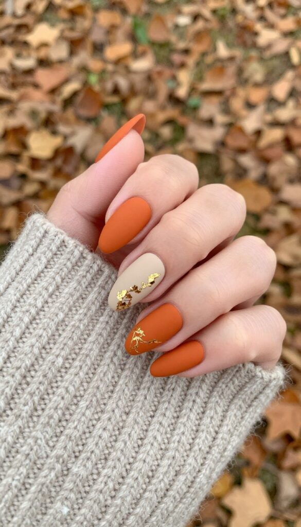 Matte pumpkin spice stiletto nails with gold foil accent