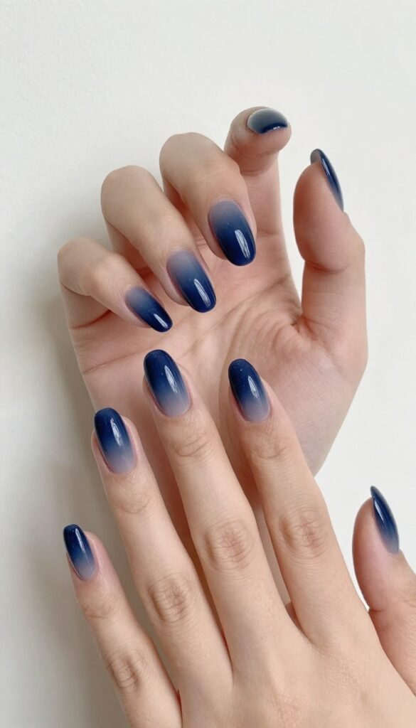 Moody indigo eclipse gradient nails with dark base and smoky gray tips
