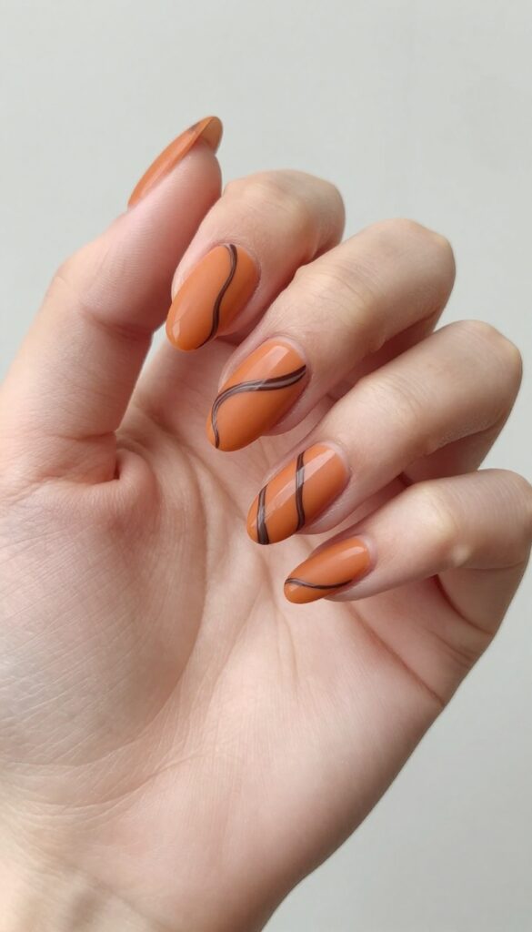 Burnt orange and chocolate swirl nails, matte finish, almond shape, fall manicure