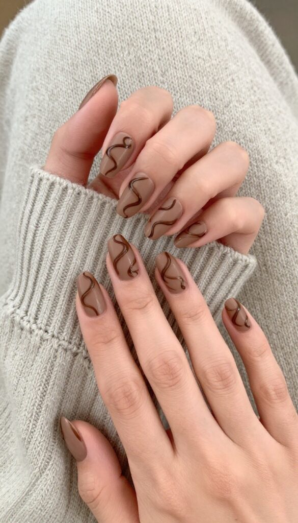 Chocolate swirl accent nails with creamy cocoa base and espresso swirls, matte finish, almond shape
