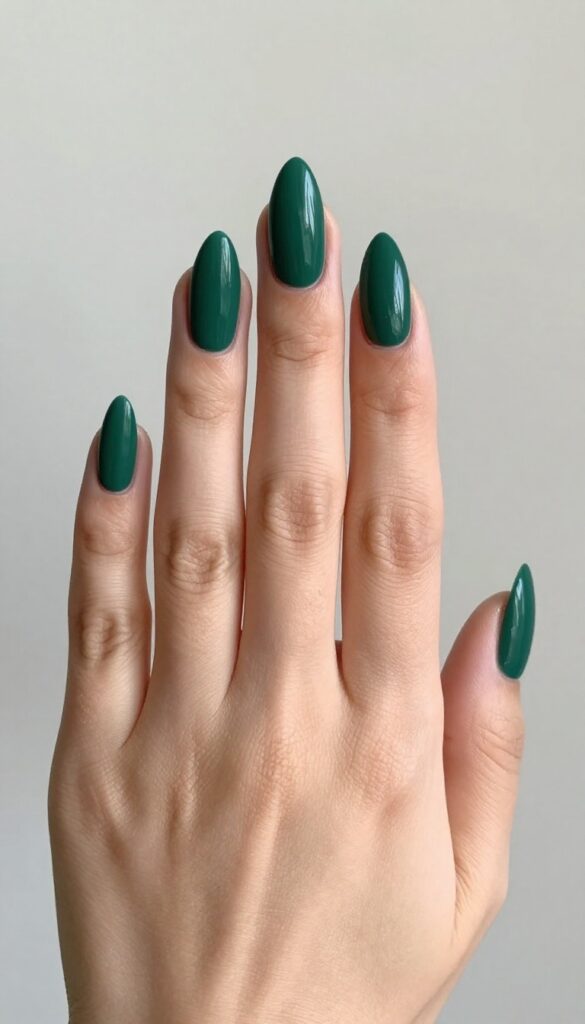 Matte emerald stiletto nails with gold jewelry