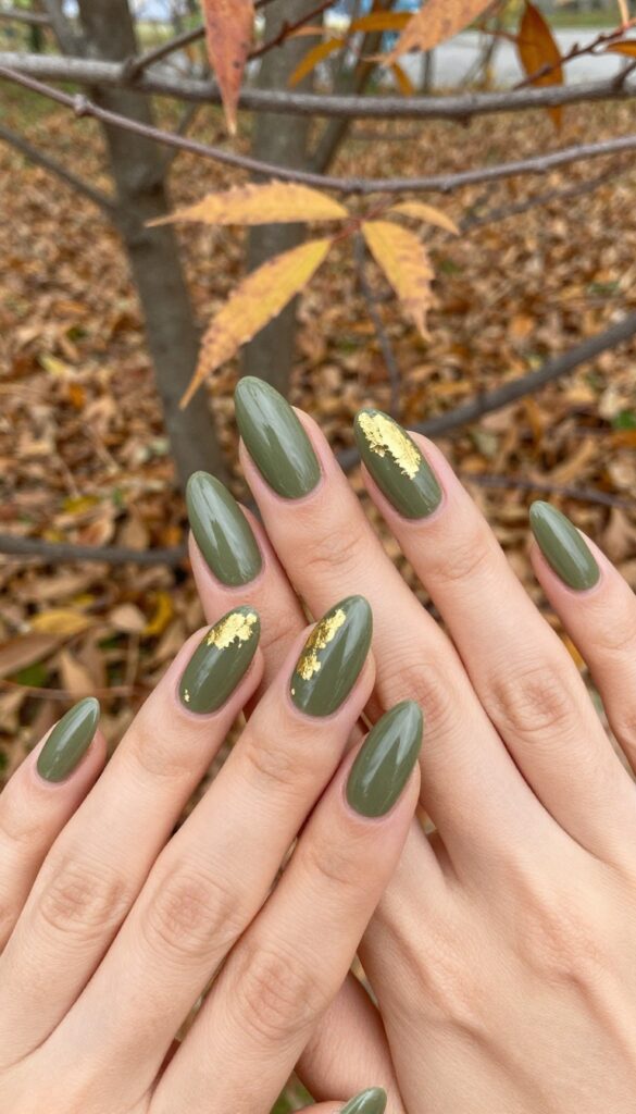 Olive green stiletto nails with gold foil accents
