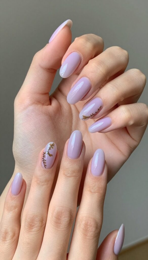Muted lavender nails with pressed fern fronds, glossy top coat, autumn floral manicure