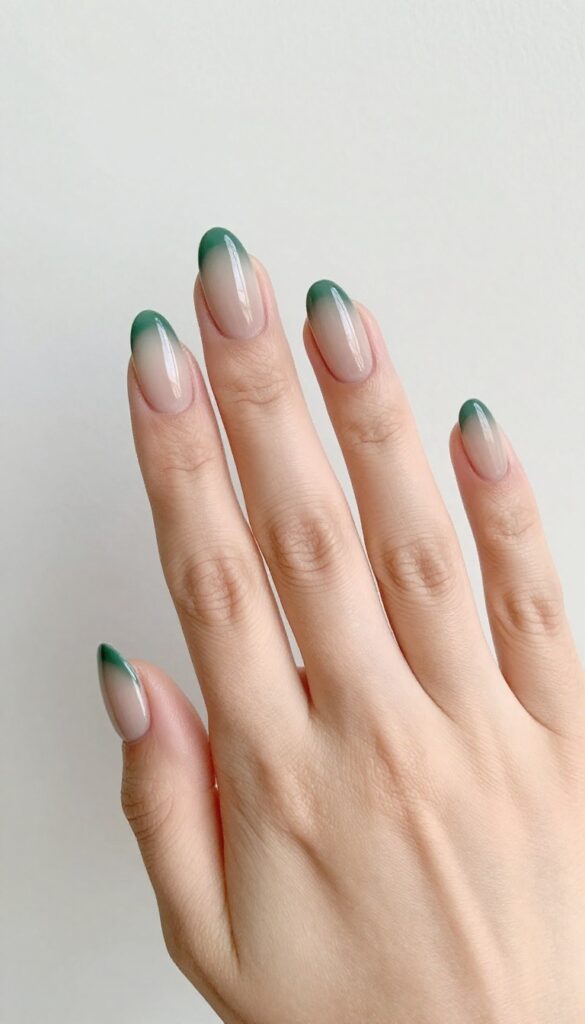 Mossy ombre nails with nude to forest green gradient on almond-shaped nails