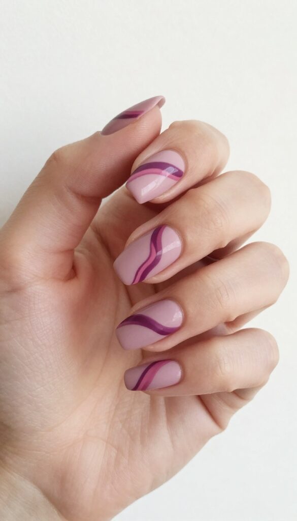 Matte mauve nails with abstract plum and dusty rose swirls