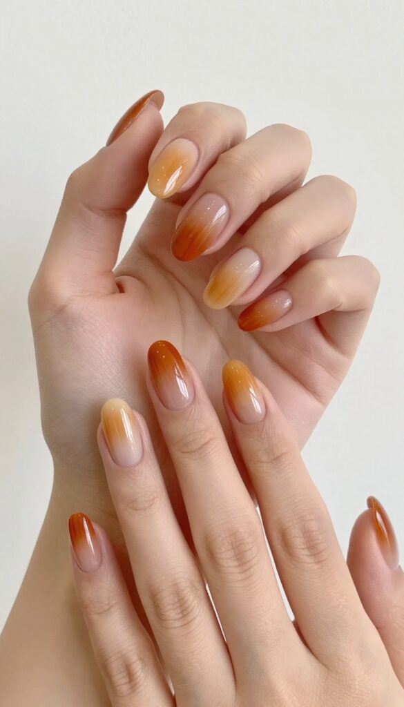 Pumpkin spice ombre nails with almond shape and glossy finish