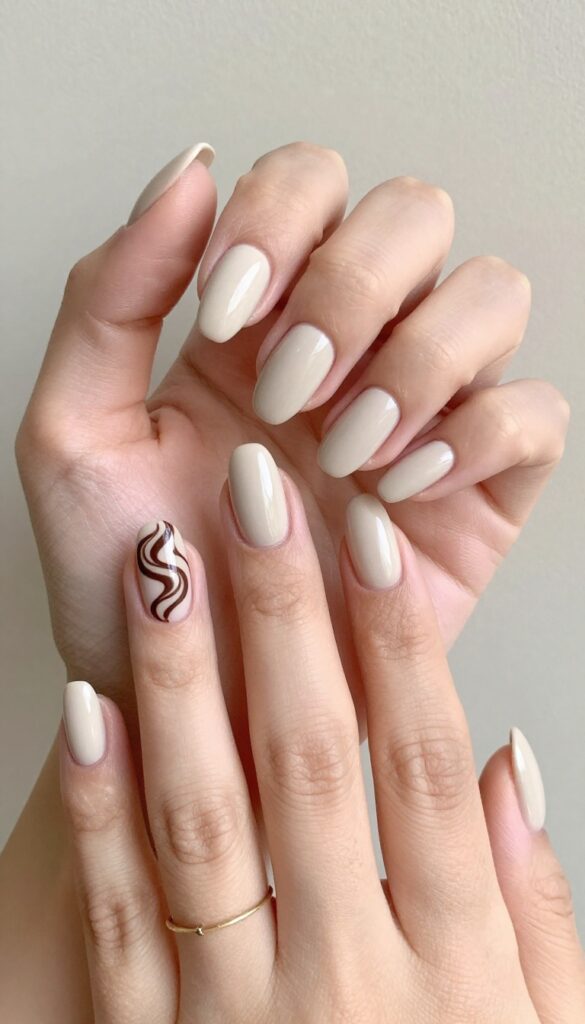 Chocolate swirl accent nails on nude dip powder base with matte finish