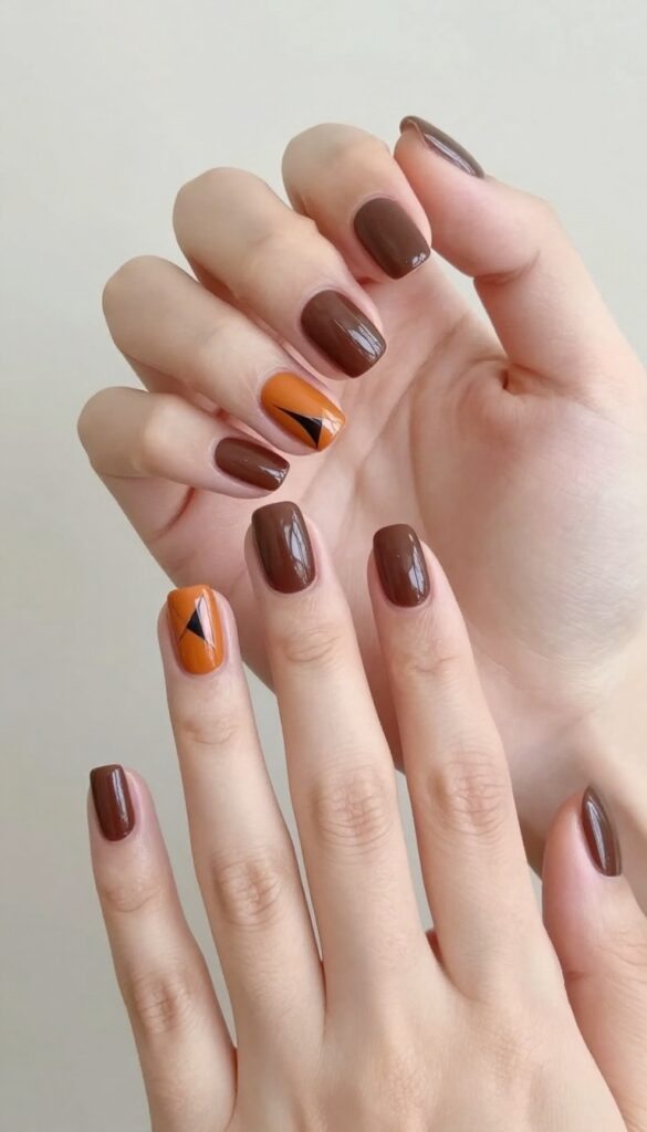Matte brown nails with glossy burnt orange geometric tips