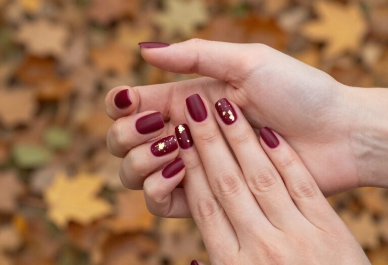 Matte merlot nails with gold foil flakes on medium square nails for fall