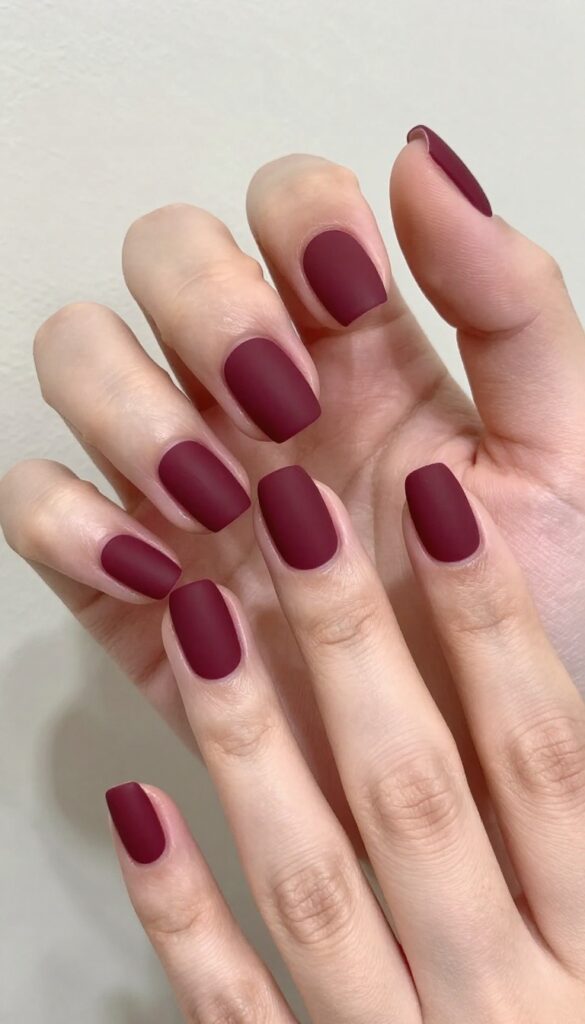 Matte burgundy nails with negative space design
