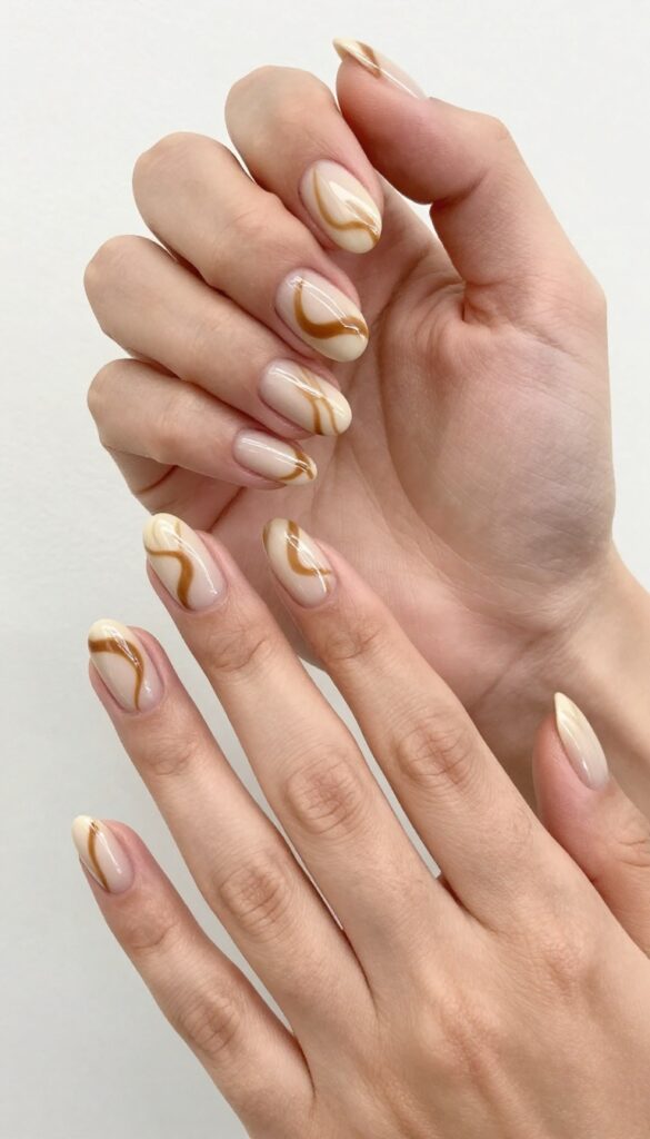 Mocha swirl nails with espresso latte art design on almond-shaped nails