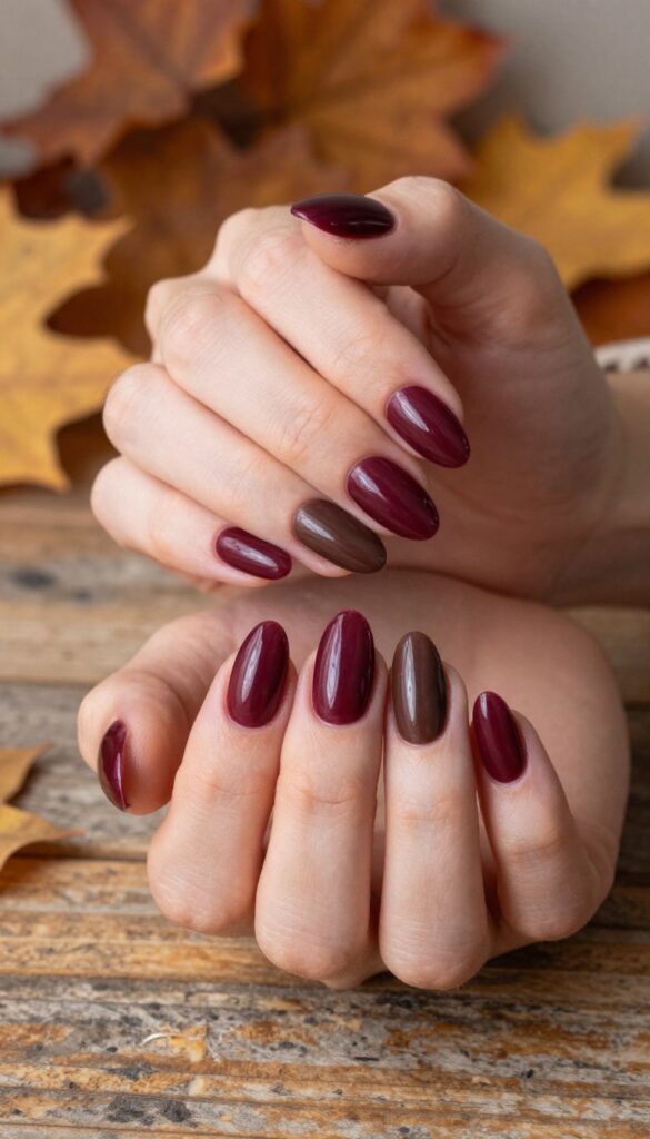 Chocolate cherry ombre dip powder nails in almond shape with glossy finish