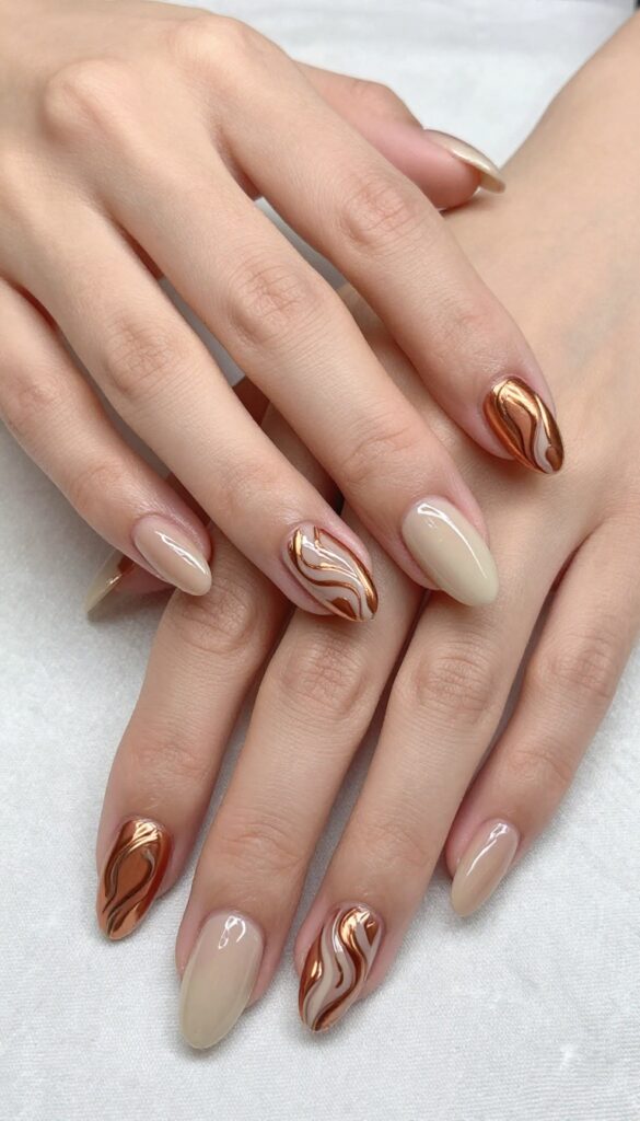 Copper and cream swirl nail design on almond-shaped nails with glossy finish