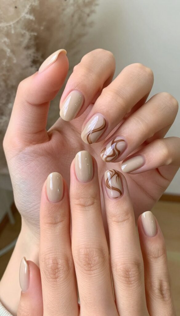 Mocha swirl nail art on rounded squoval nails with glossy finish