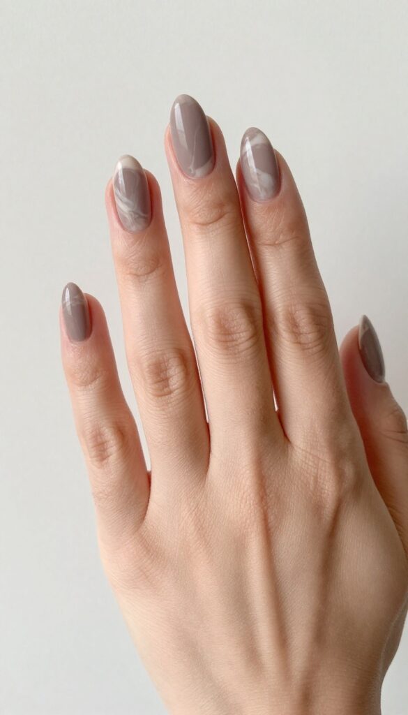 Two-tone matte marble nails on almond-shaped nails with taupe base and cream swirls