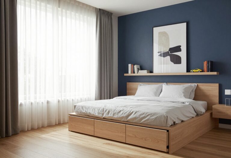 Bright boys bedroom with a built-in platform bed featuring deep storage drawers, neutral wood and navy tones, and clean uncluttered styling